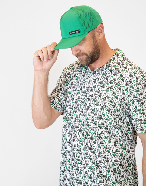 Man wearing kelly green hat with "LUKE 18:1" text