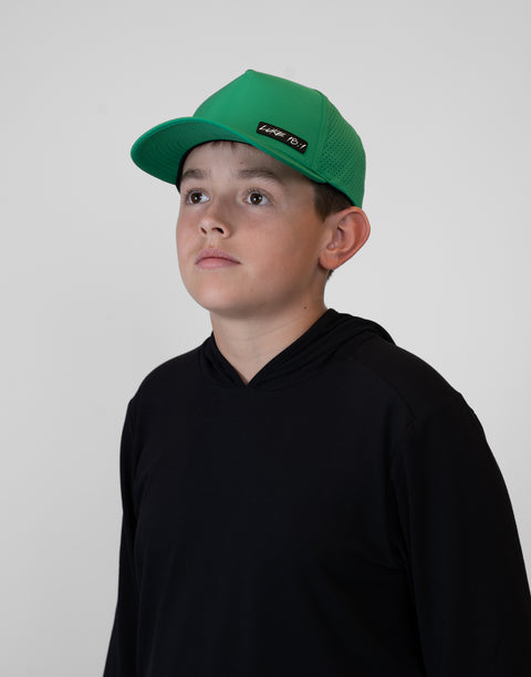 Child wearing kelly green hat with "LUKE 18:1" text