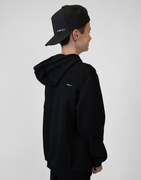 Rear view of boy wearing Youth Black Fleece Hoodie showing "LUKE 18:1" text on  upper right back