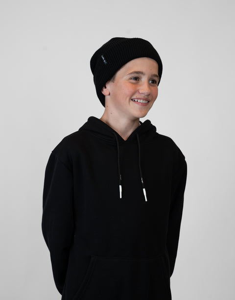 person wearing black beanie with "LUKE 18:1" text