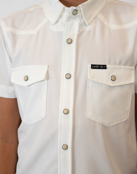 Boy wearing Youth White S/S Pearl Snap Shirt showing "LUKE 18:1" text on pocket