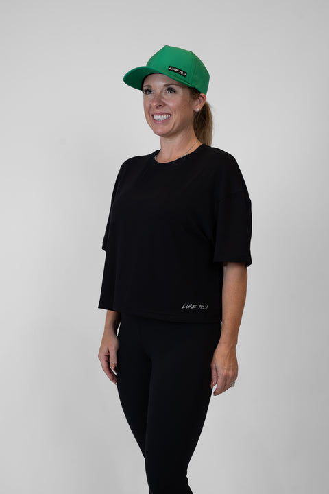 Woman wearing ladies Bamboo Mid-Crop Tee with "Luke 18:1" text above bottom seam