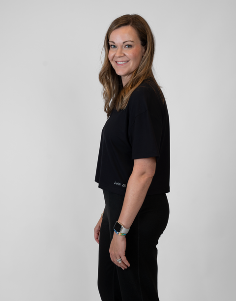 side view of woman wearing ladies Bamboo Mid-Crop Tee with "Luke 18:1" text above lower seam