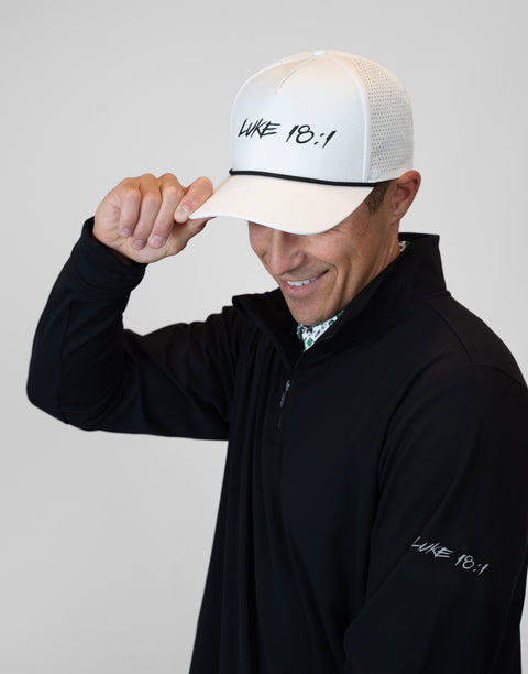 Man wearing Men's black Performance 1/4-Zip with "LUKE 18:1" text on sleeve
