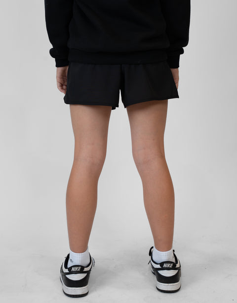 Rear view of girl wearing girls black flowy performance short