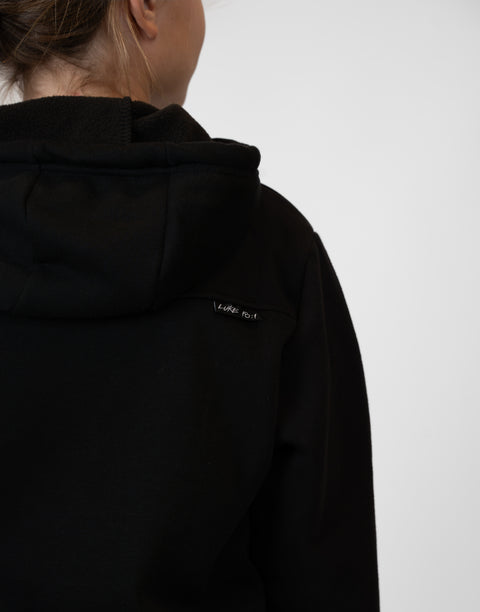 Rear view of Girl wearing Youth Black Fleece Hoodie showing "LUKE 18:1" text on upper right back