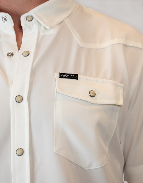 Man wearing Men's White S/S Pearl Snap Shirt showing "LUKE 18:1" text on pocket