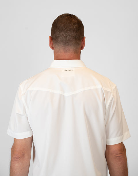 rear view of Man wearing Men's White S/S Pearl Snap Shirt showing "LUKE 18:1" text on upper back