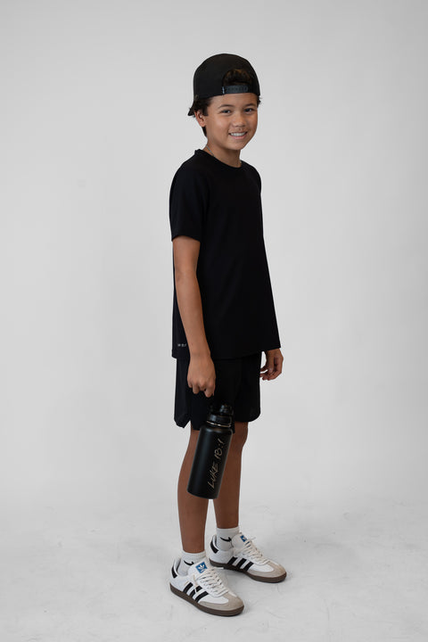 Person holding a black water bottle with 'Luke 18:1' text on a white background