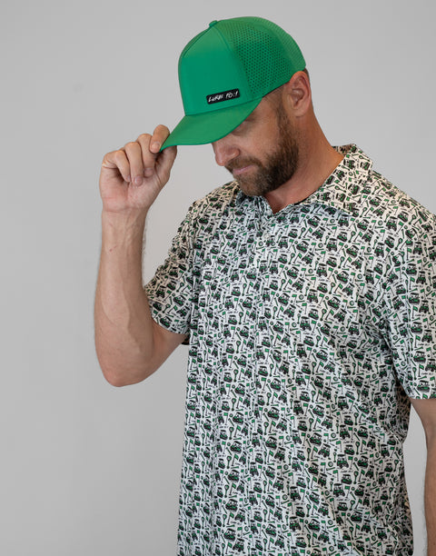 Man wearing kelly green hat with "LUKE 18:1" text